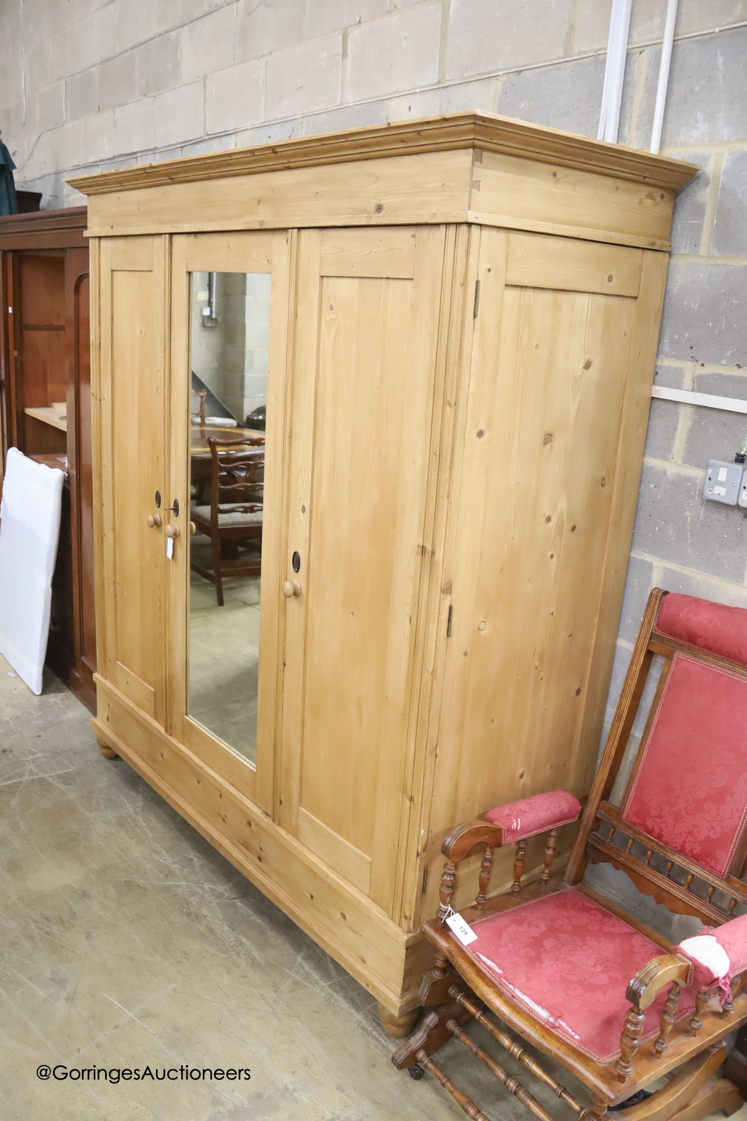 A 19th century East European pine knock-down mirrored wardrobe, width 180cm depth 70cm height 200cm